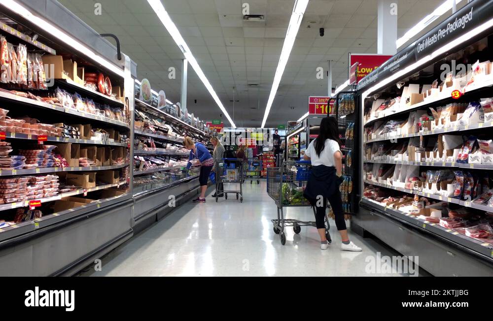 People looking for fresh meat inside Walmart store at seafood