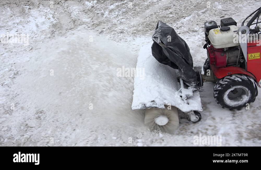 Snowblower clean snow from sidewalk in winter. 4K Stock Video Footage