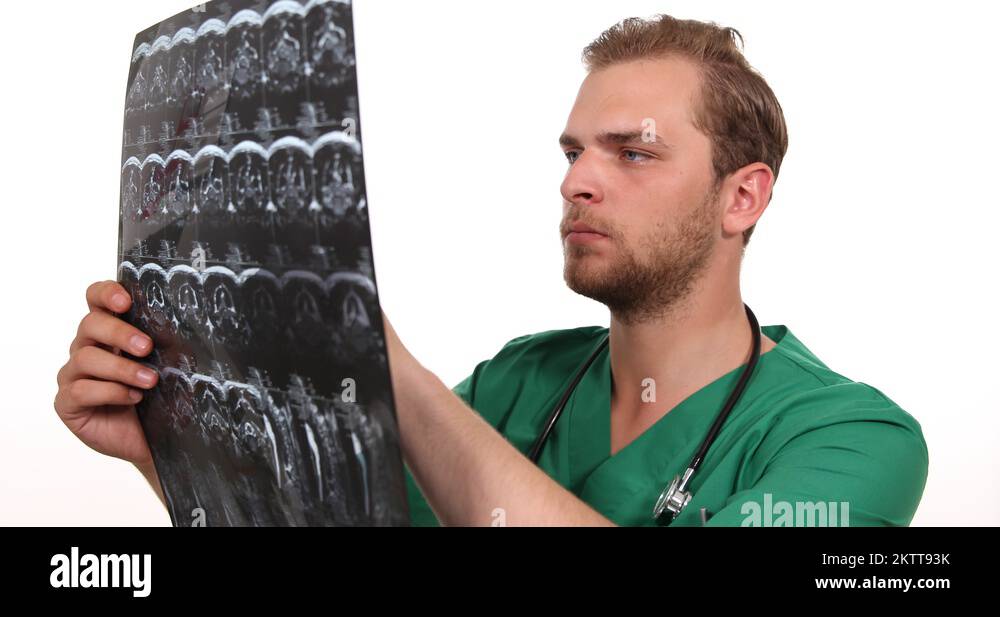 Medical Doctor Man Holding and Examining a CT Scan Computer Scanner