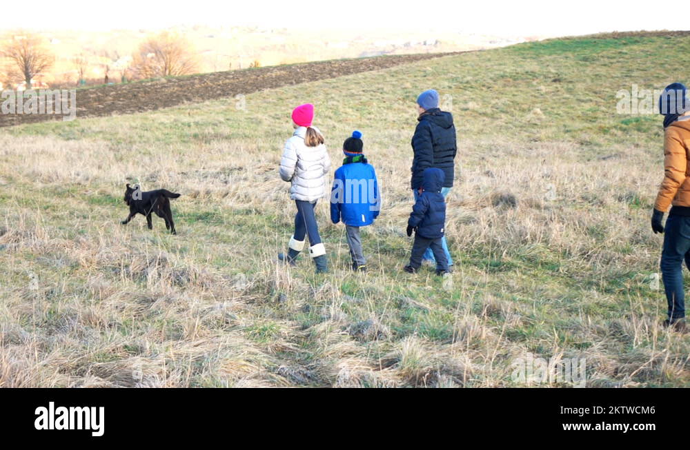 Family with dog on the walk in the country, super slow motion Stock