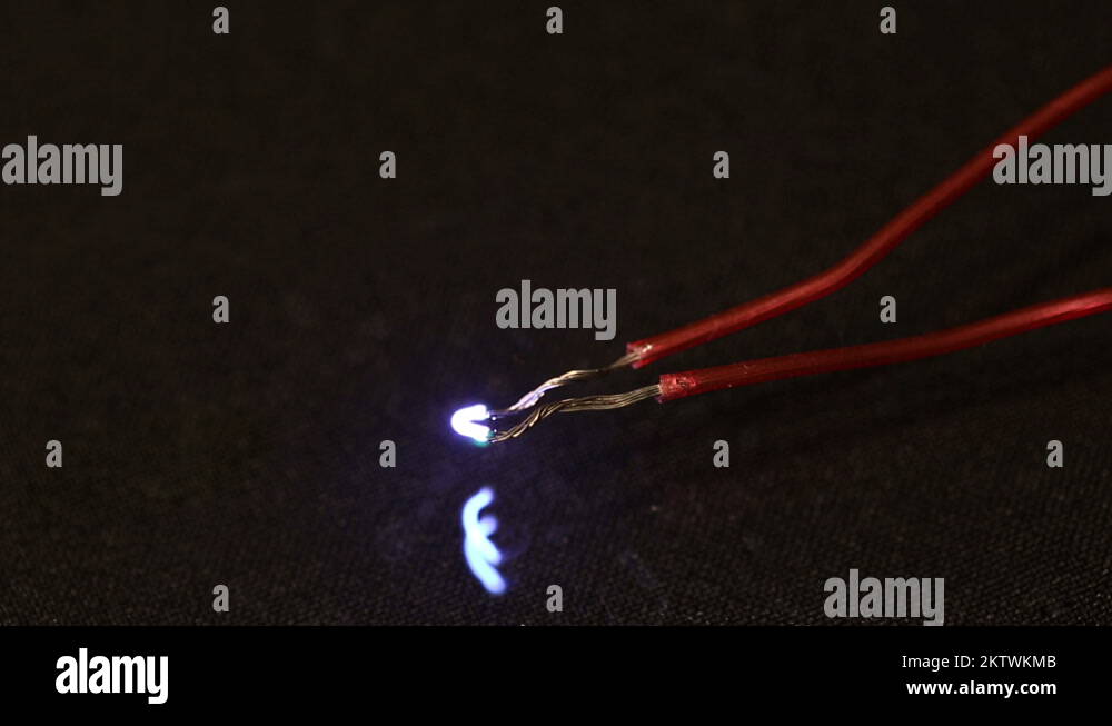 Electrical spark between two insulated wires. Electric arc Stock Video Footage Alamy