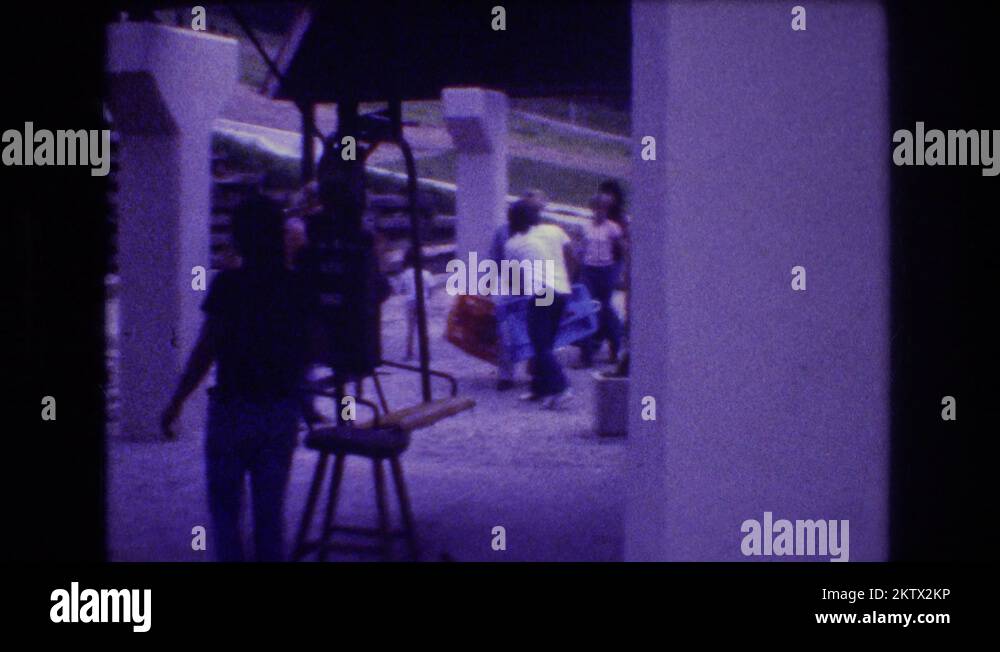 1976 a young man in a tee shirt works as a chair lift operator at a
