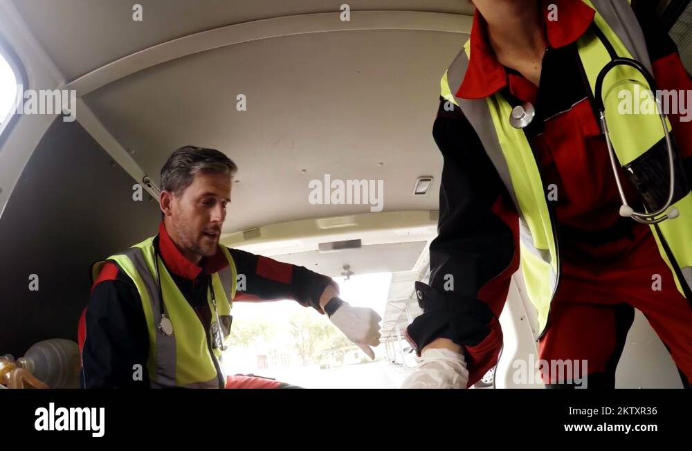 Paramedic using an external defibrillator during cardiopulmonary