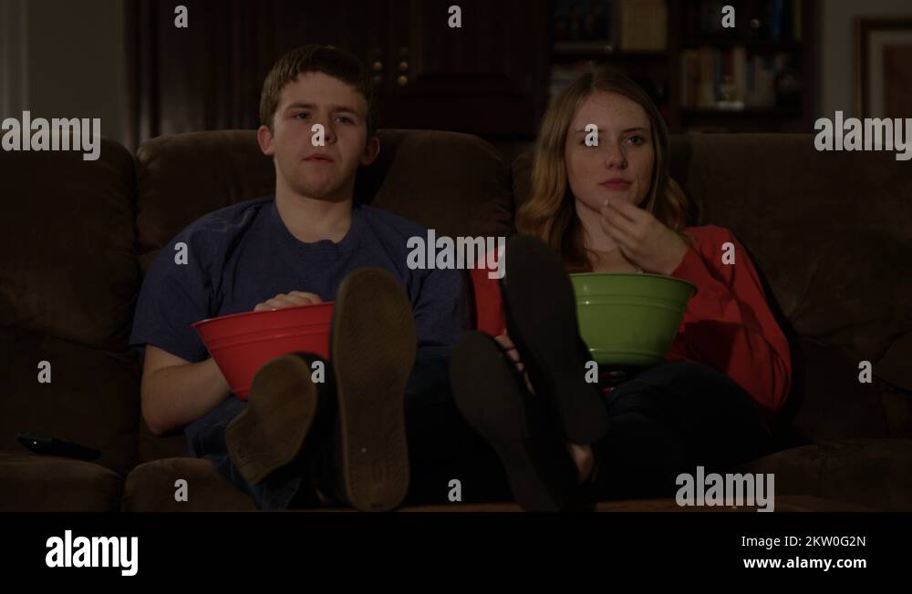 Brother sister eating popcorn watching Stock Videos & Footage HD and