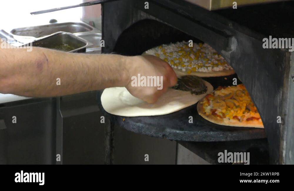 Making Mediterranean Pita Bread style pizza with corn, cheese, zaatar