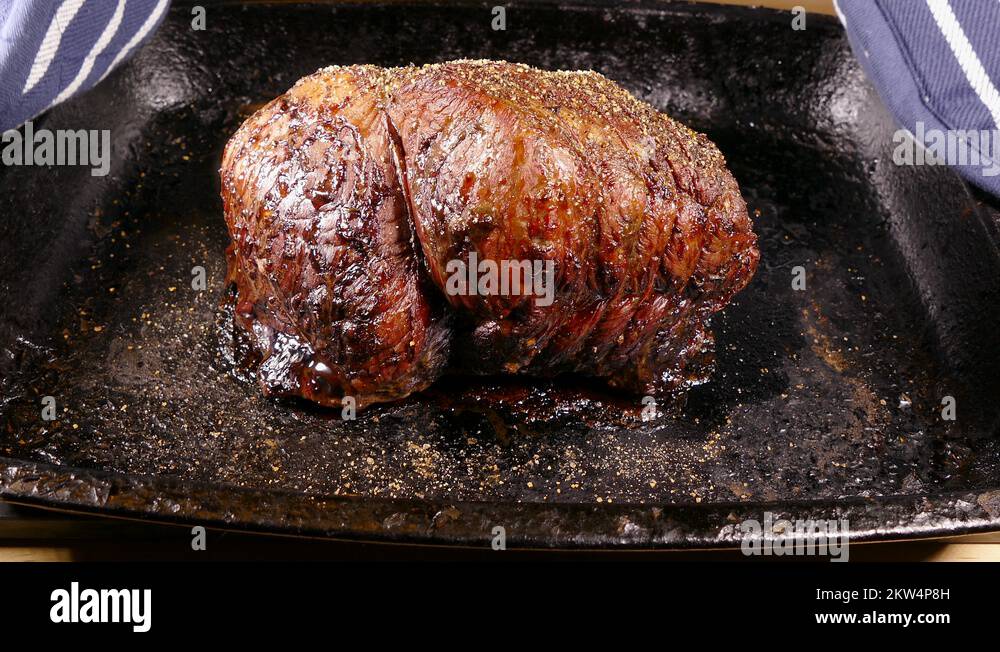 A joint of cooked roast beef straight from the oven Stock Video Footage Alamy