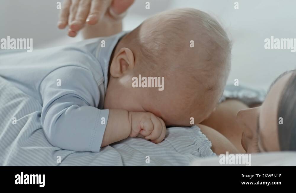 Crying Baby Lying on Mothers Chest Stock Video Footage Alamy