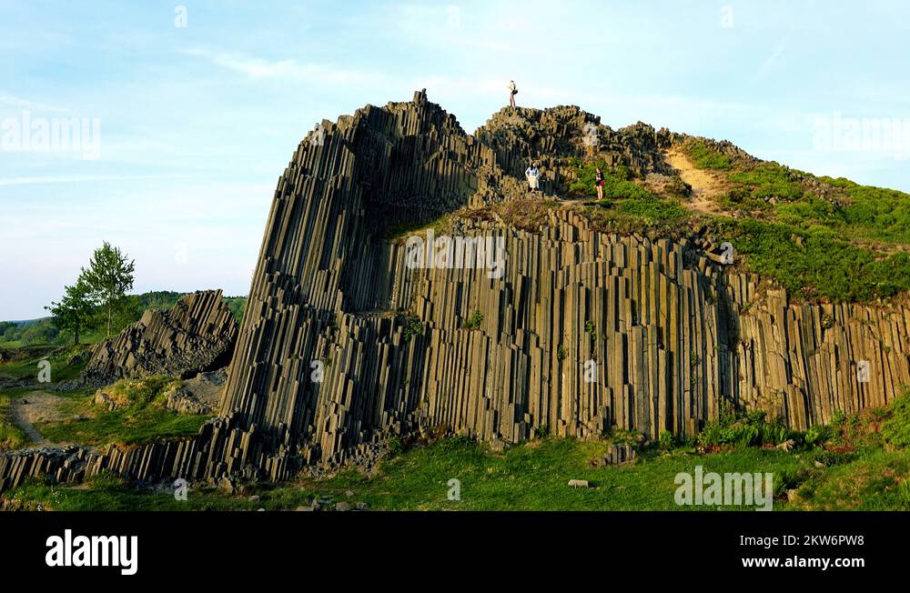 Big stone mountain with some people on the top of mountain blue sky Stock Video Footage Alamy