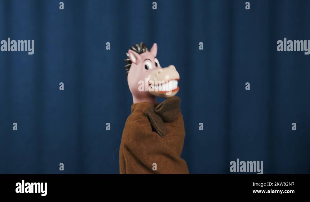 Horse hand puppet nodding head and shaking on scene with blue