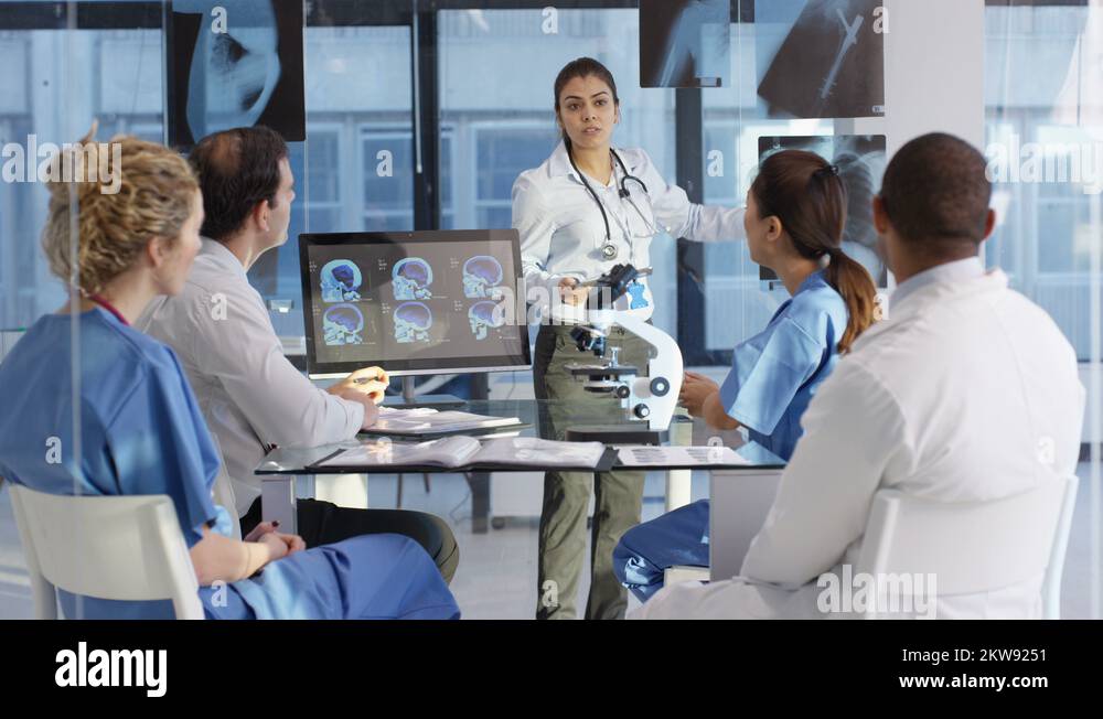 4K Medical team in a meeting, using technology to look at brain scans ...