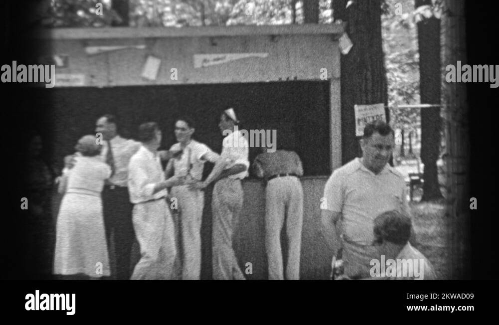 1937 group of adults at a concession stand posing and talking to the