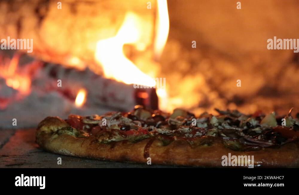 Well Done Pizza Lots of Toppings in Wood Fired Oven Stock Video Footage