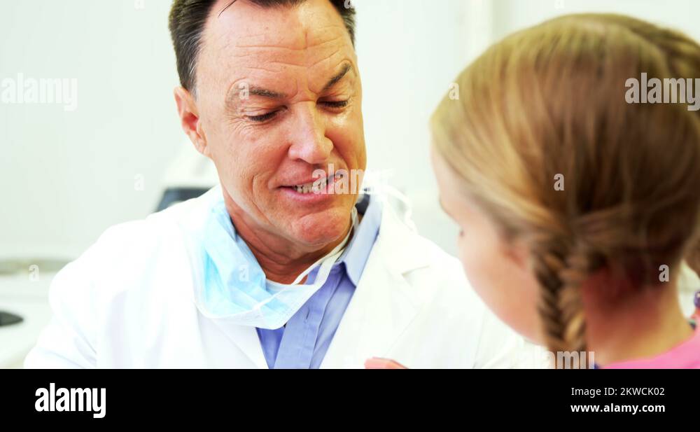 Dentist showing young patient how to brush teeth Stock Video Footage