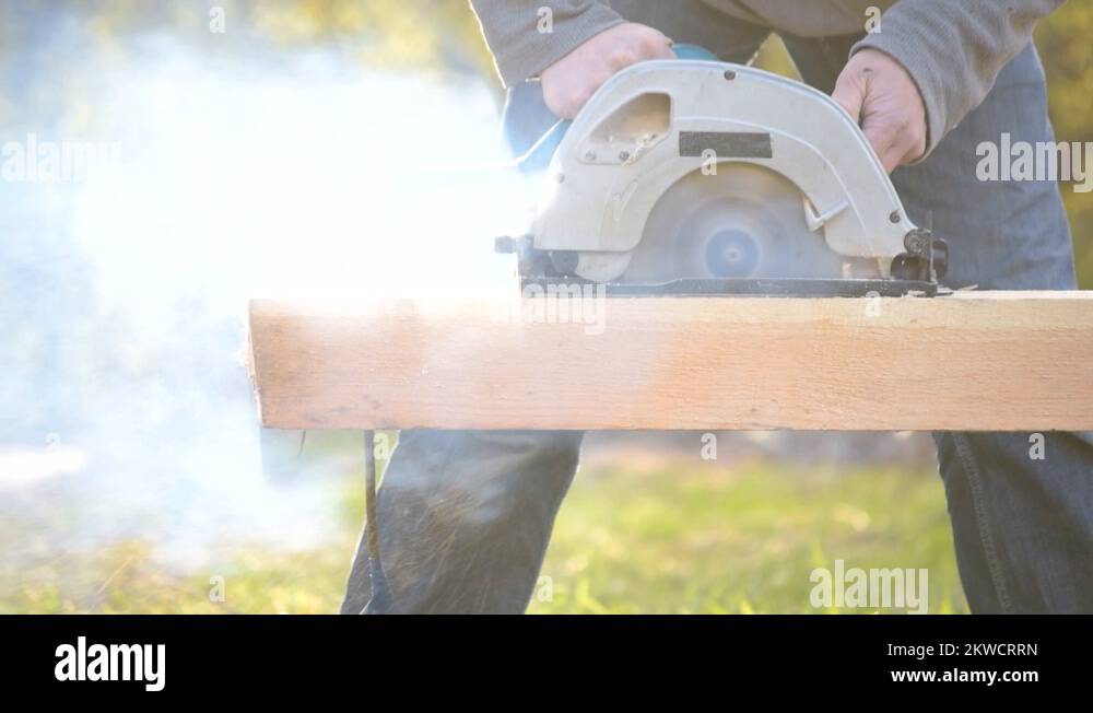 Sawing wooden beam with a blunt, not sharp circular hand saw Stock