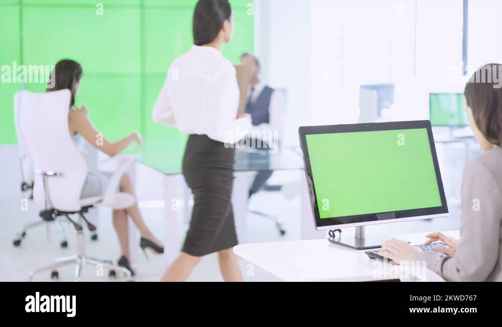 4k business team in modern office green screen on video wall computer