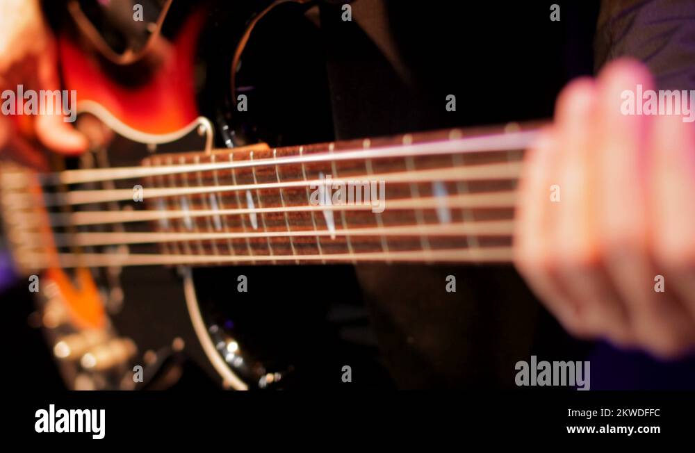 Bass Player Hands Playing Rock Music with Bass Guitar in the