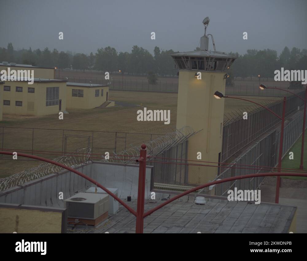 35MM 2K EXT. DUSK STATE PRISON MS TOWER AND GROUNDS CAM CRANES OVER