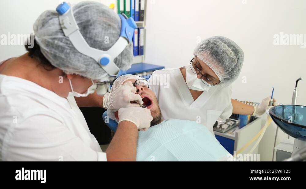 Dentist Man Extraction Surgery Pull Up Tooth with Removal Tool Dental