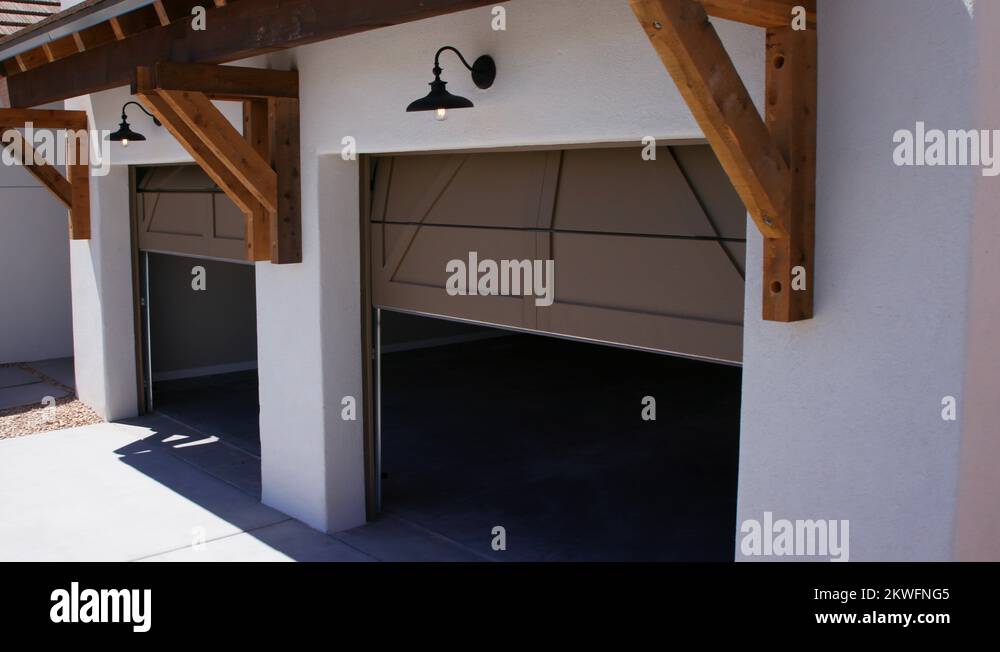 Two Garage Doors Close Lowering View from Corner Angle of Garage Stock