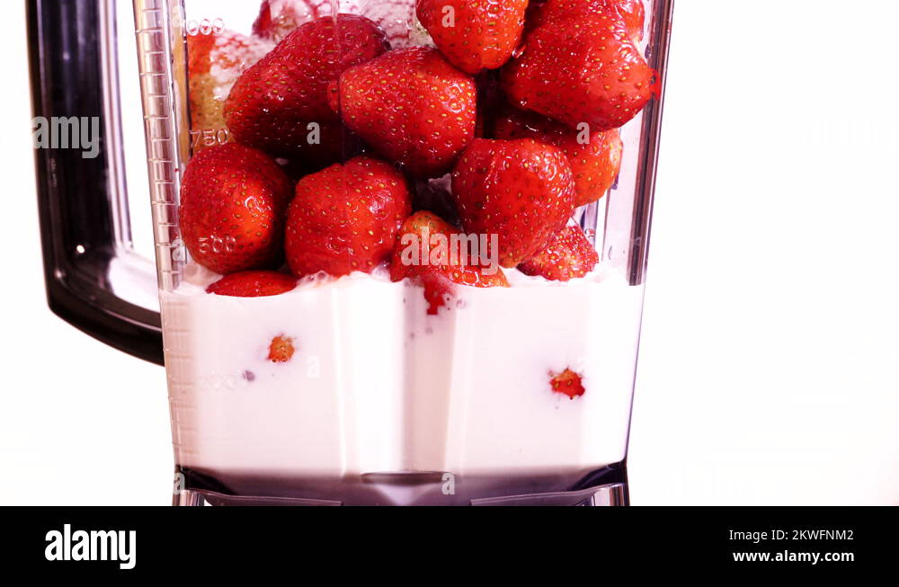 Making strawberry fruit shake in blender on white 4K Stock Video