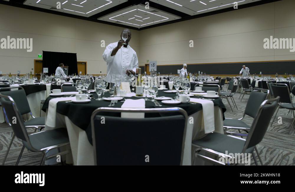 Waiters and waitresses setting tables in a venue Stock Video Footage