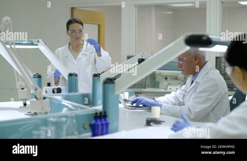 Scientist mixing substance in an Erlenmeyer flask Stock Video Footage Alamy
