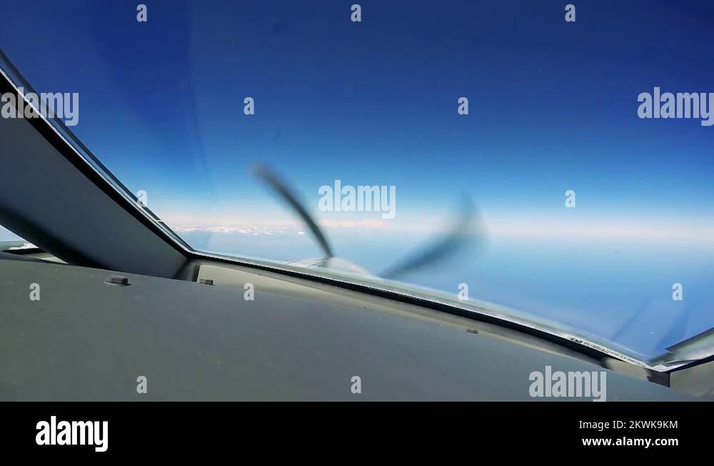 A private plane flies a view from the cockpit spinning propeller