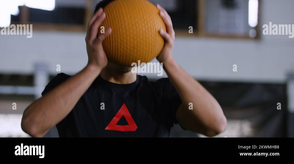 Male athlete throwing medicine ball in football stadium Stock Video