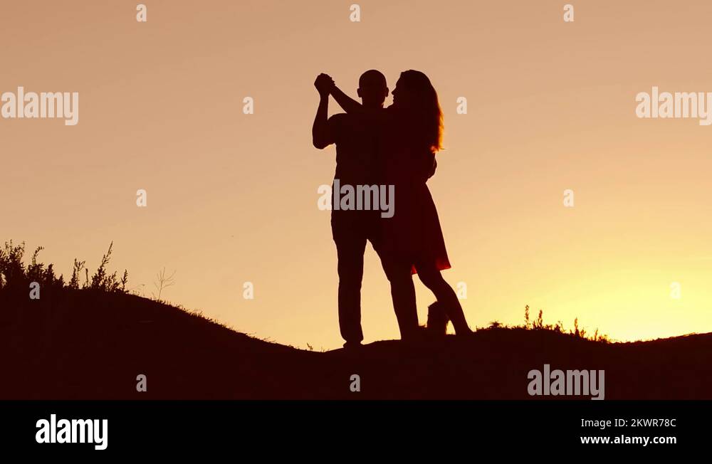 Couple in love dancing silhouette at sunset nature and kissing. Loving ...