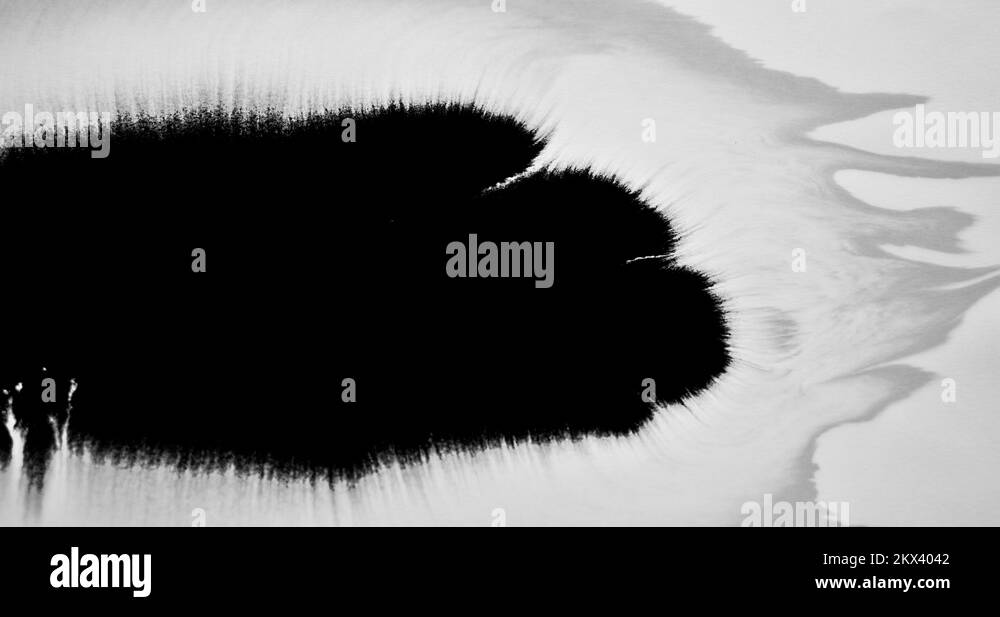 Pretty ink flow and bleeding across white background paper Stock Video