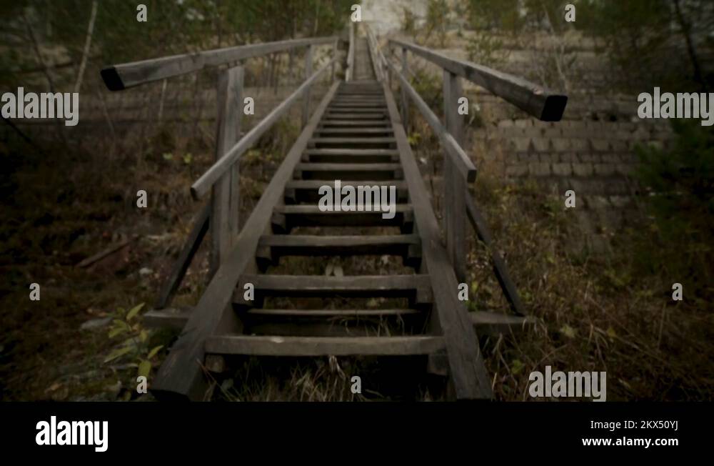 A man going up the stairs on a mysteryous way of life. Footage. A man
