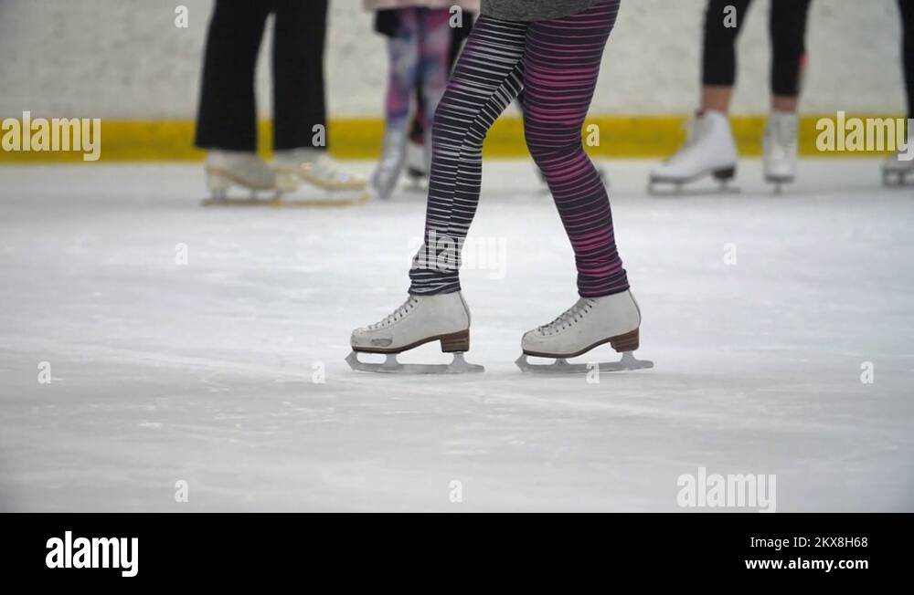Sport ice skating girls learns how to skate at the indoor ice arena