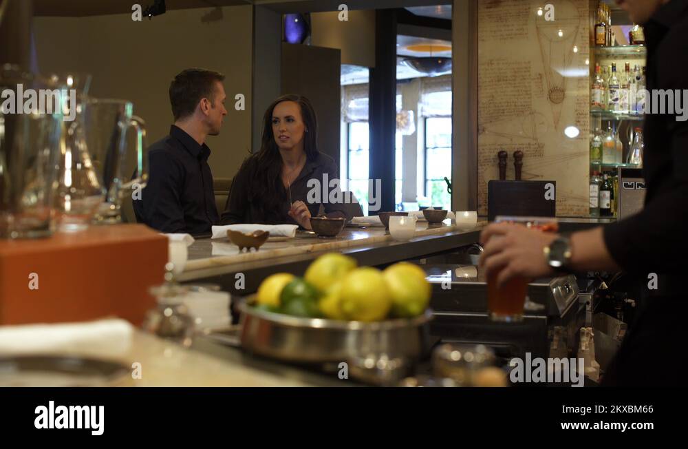 Waiter serving alcohol to a young couple in a bar Stock Video Footage