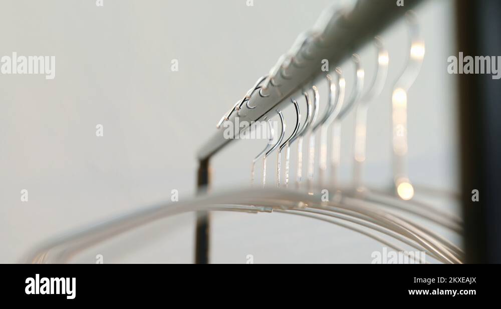 Hangers arranged on clothes rack 4K 4k Stock Video Footage - Alamy