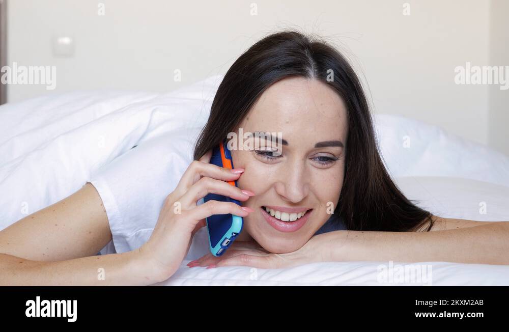 Female with telephone lying down on the bed Stock Video Footage Alamy