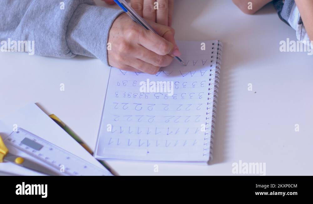 Mother helping son writing numbers in copybook Stock Video Footage - Alamy
