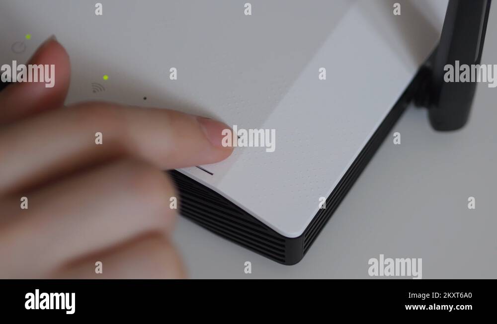 Female Finger Presses The Button On Wi-Fi Router On White Desk Stock ...