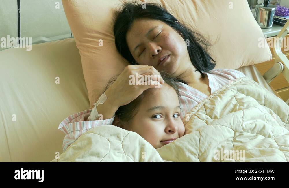 Tween girl in hospital bed with sick mother Stock Video Footage Alamy