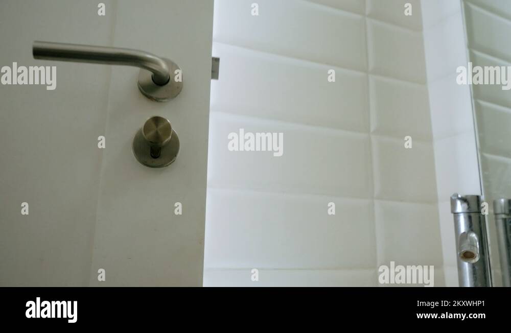 Man hand behind door holding new toilet paper. Returning finished