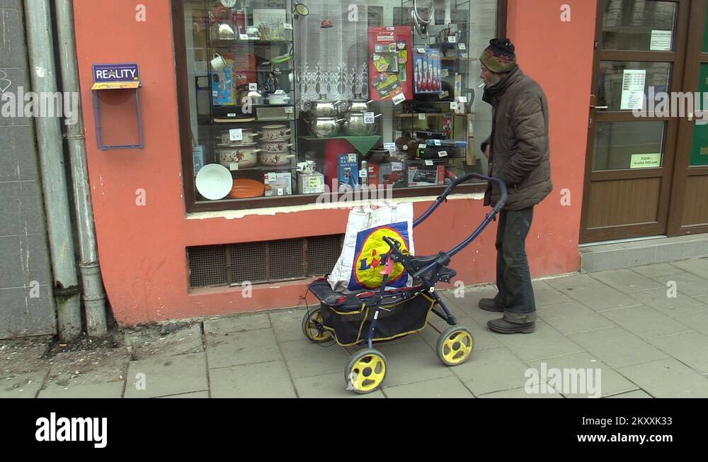 Authentic poor homeless hand cigarette smokes and smoking with a cart