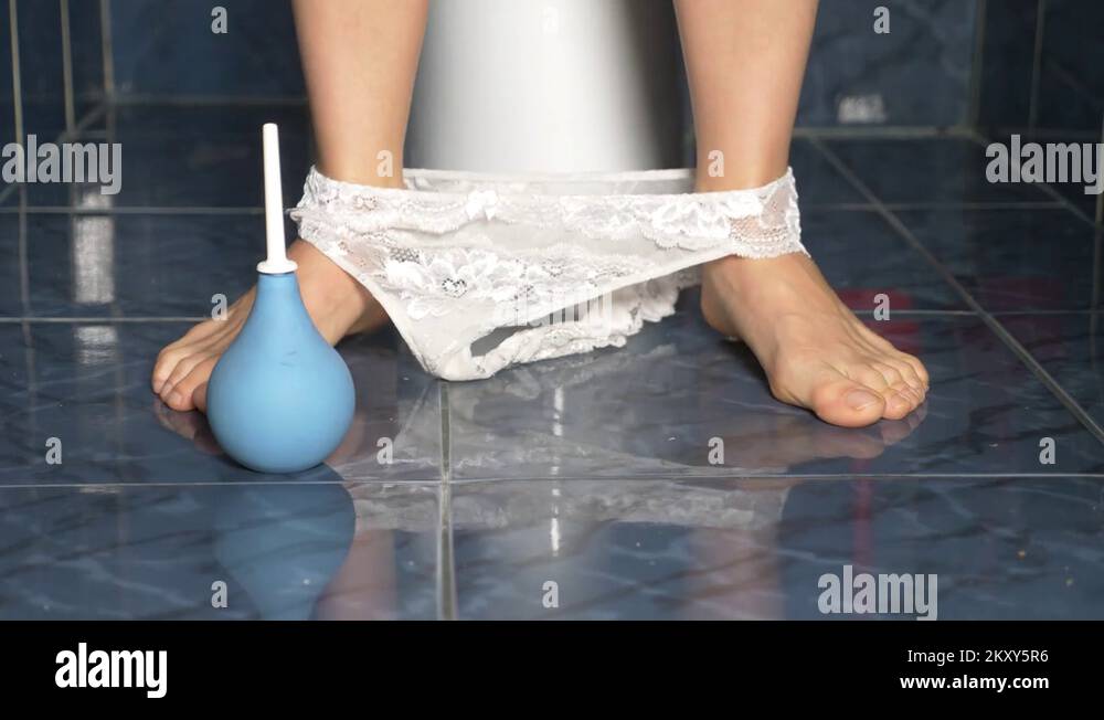 the feet of a man who sits in the toilet with a pain in his stomach. 4k ...