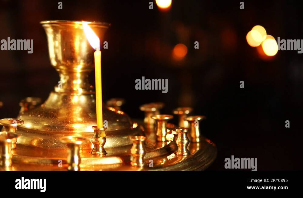 One candle in the candlestick of the Christian temple Stock Video