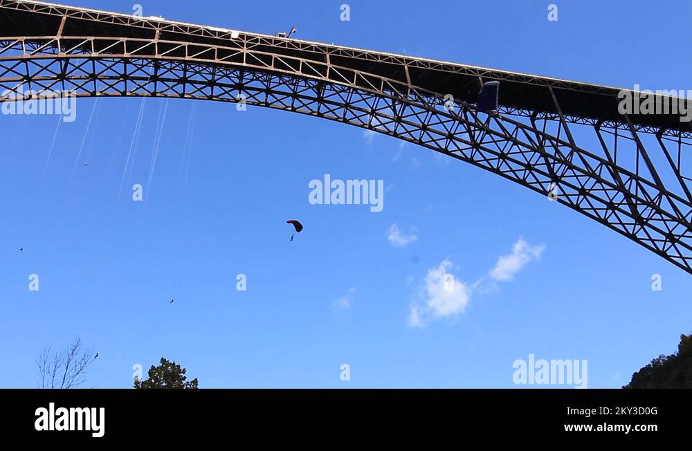 Base jumpers in air under the New River Bridge Stock Video