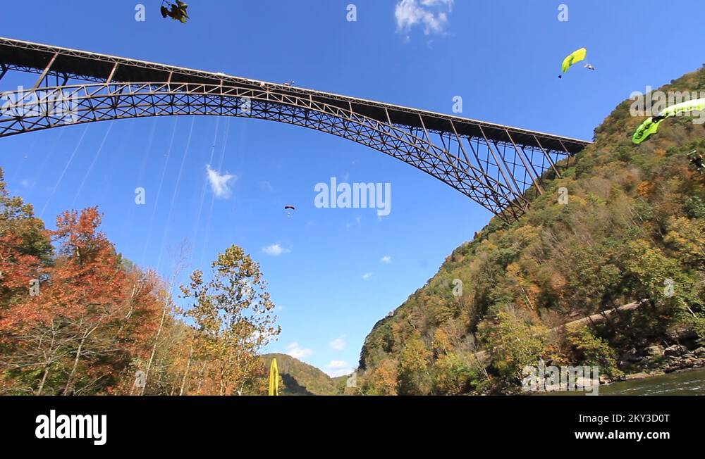 Base Jumpers in air at the New River Gorge Bridge Stock Video Footage