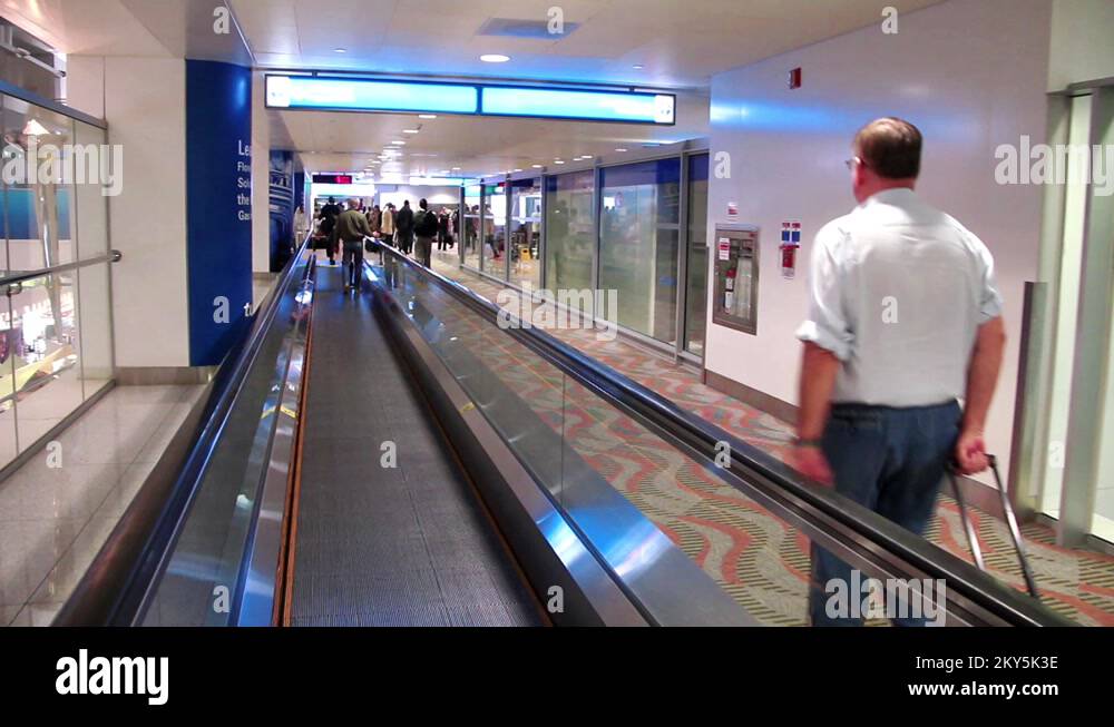 People on travelator in Dubai international airport Stock Video Footage