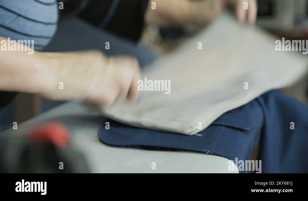 Process of ironing male jacket on the garment factory. 4K Stock Video