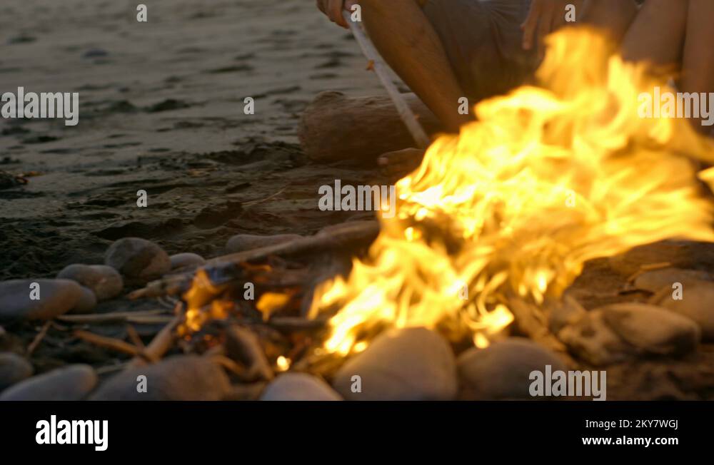 Couple Sitting by Fire on Romantic Date on Beach Stock Video Footage Alamy