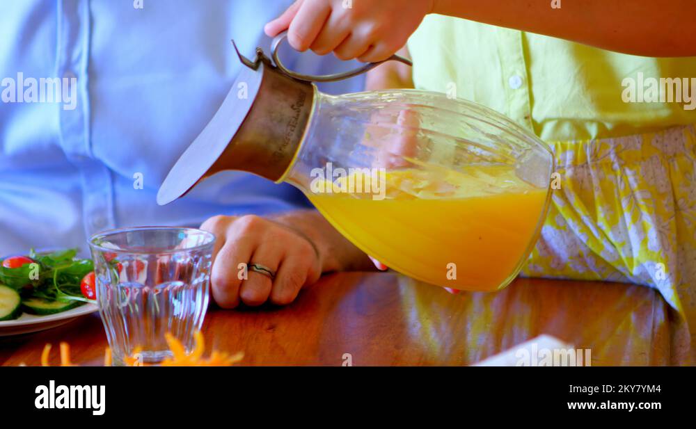 Girl pouring juice into glass at home 4k Stock Video Footage Alamy