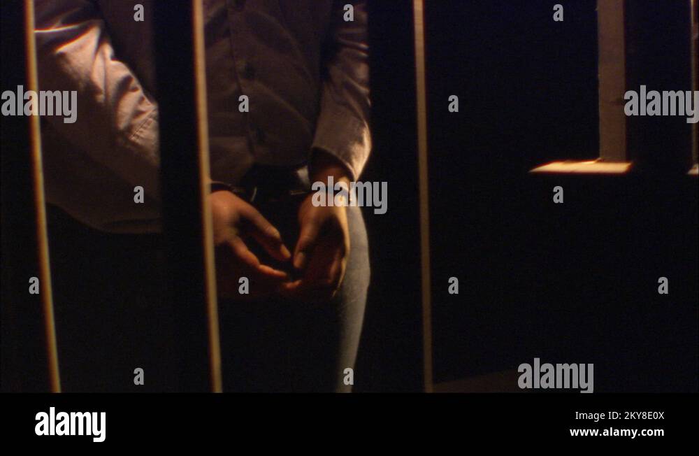 AfricanAmerican arrested with handcuffs, Jail Cell Dark room