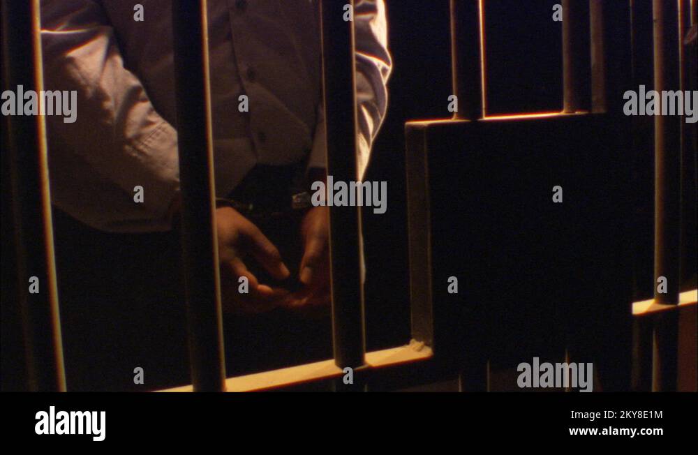 AfricanAmerican arrested with handcuffs, Jail Cell Dark room
